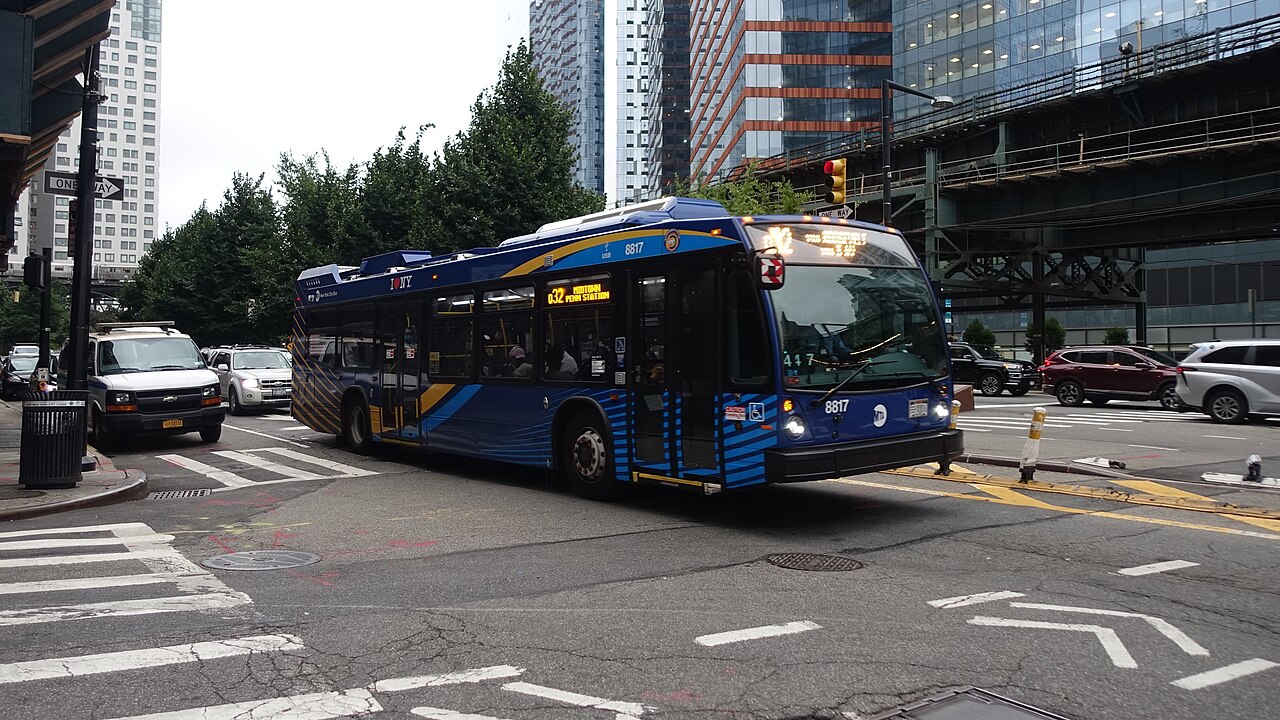 A blue and yellow Q32 bus at Queens Plaza North and 28th Street in Long Island City.